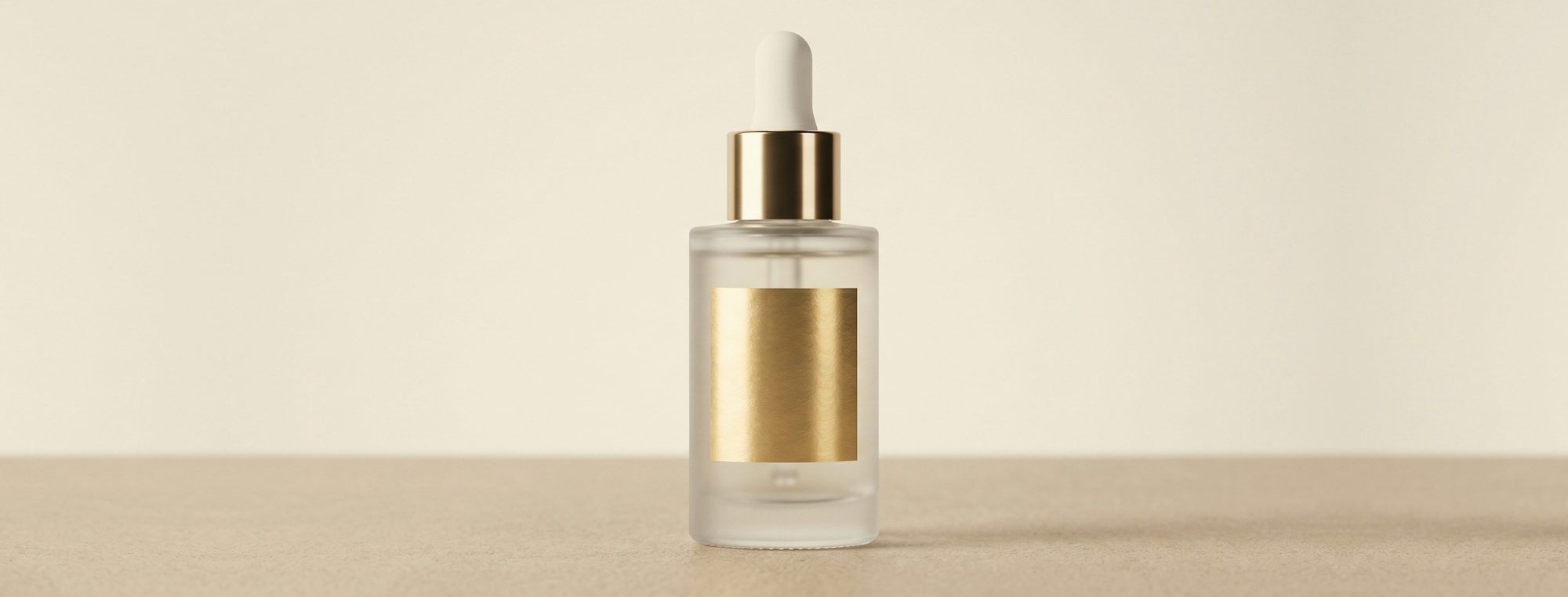 Frosted dropper bottle with gold cap and blank label